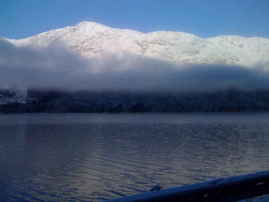View across Loch Linnhe to snow capped mountains and a cloud inversion